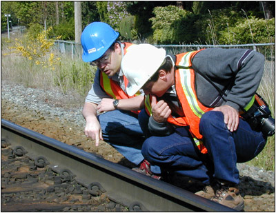Rail employees checking rail track set up