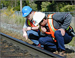 Rail employees checking rail track set up