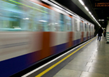 London underground train passing through a station